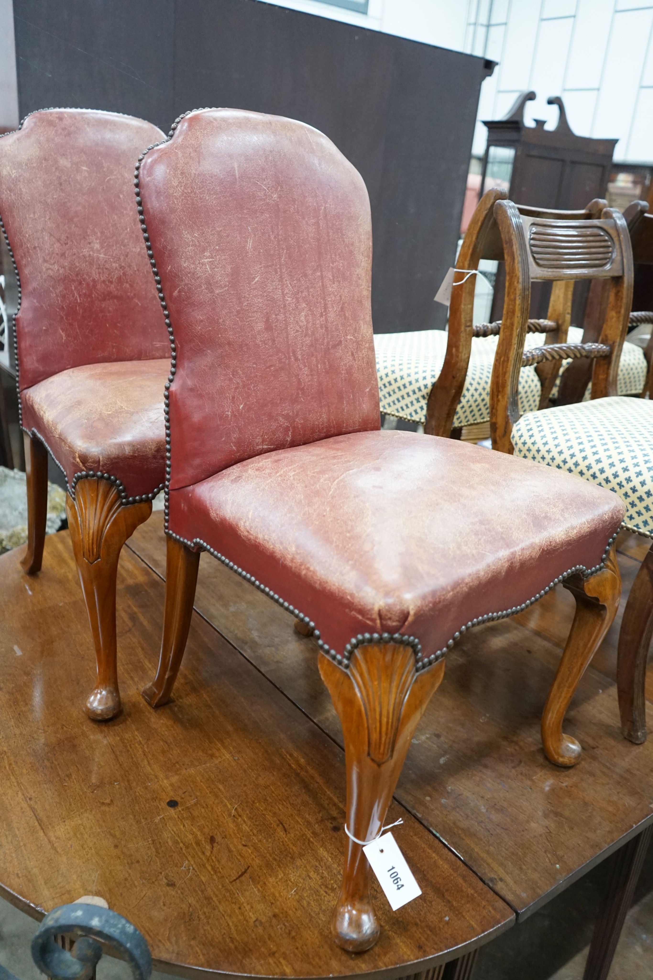 A pair of George II style walnut and red leather side chairs, width 54cm, depth 50cm, height 92cm